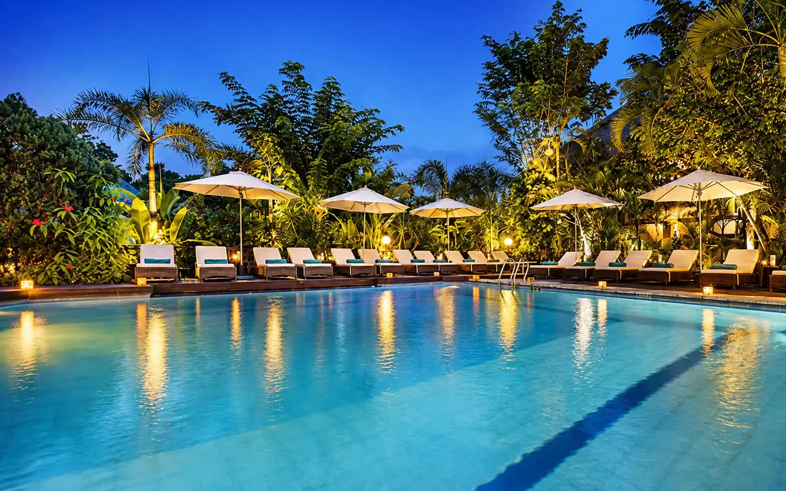 Swimming pool surrounded by tropical gardens at Bali Agung Village Seminyak